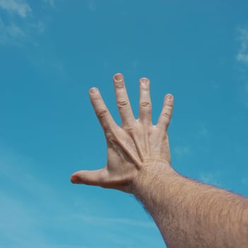 hand up in the air, gesturing in the sky feeling free photo