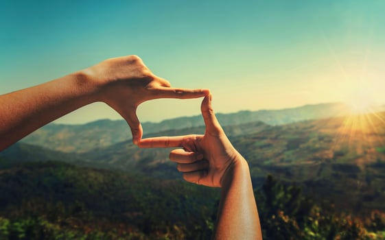 close up hand framing looking view sunrise photo