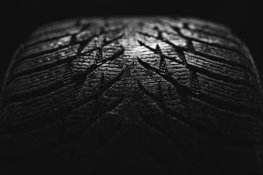 cool photo of a tire tread of a car wheel on a black background