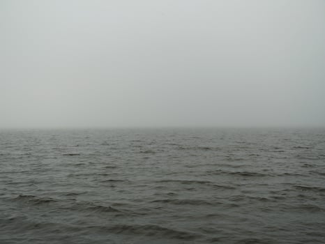 thick white fog over the cold winter sea photo