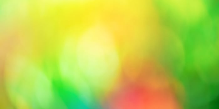 Defocus light orange green yellow red. Bokeh of autumn leaves on trees. Blurred natural background. photo