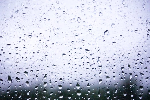 Closeup raindrops on glass and blurry background. photo