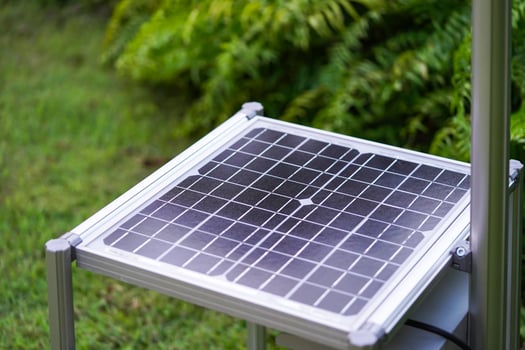 New Solar Cell is laid down among tree plant in the garden. photo