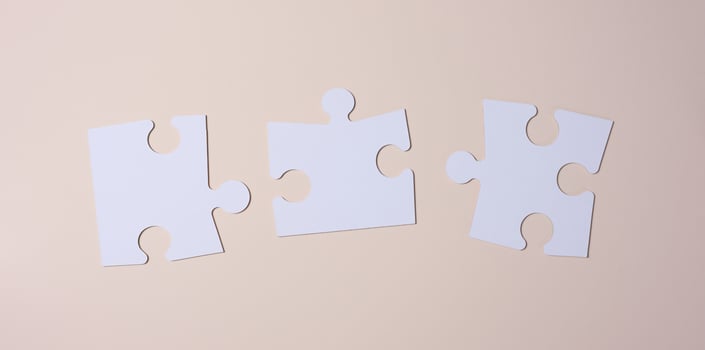 Empty white big puzzles on a beige background. Concept in business photo