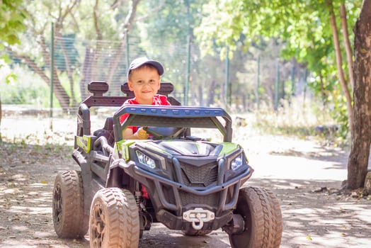 Entertainment park. Little boys compete on children's ATVs and cars. A fun pastime. Natural images with natural emotions. photo