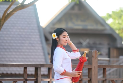 Asian woman wearing typical thai dress with red umbrella.,Thai costume photo