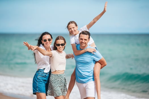 Happy family on the beach during summer vacation photo