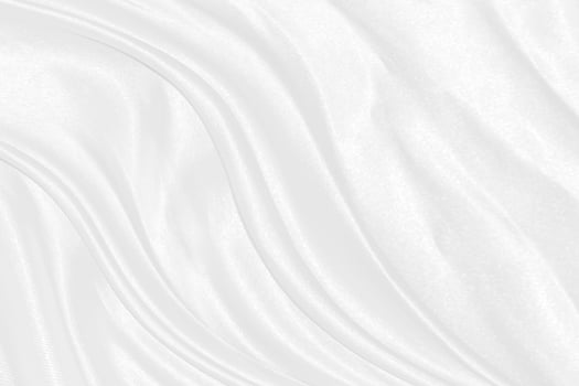 Smooth elegant white silk or satin luxury cloth texture can use as wedding background. Luxurious background design photo