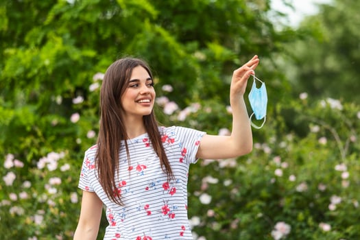 Quarantine is over Coronavirus is over we won concept. Woman with protection mask outdoor in the sunshine freedom. We are safe. Coronavirus ended. We won. No more quarantine. Breathe deep. Mask off photo