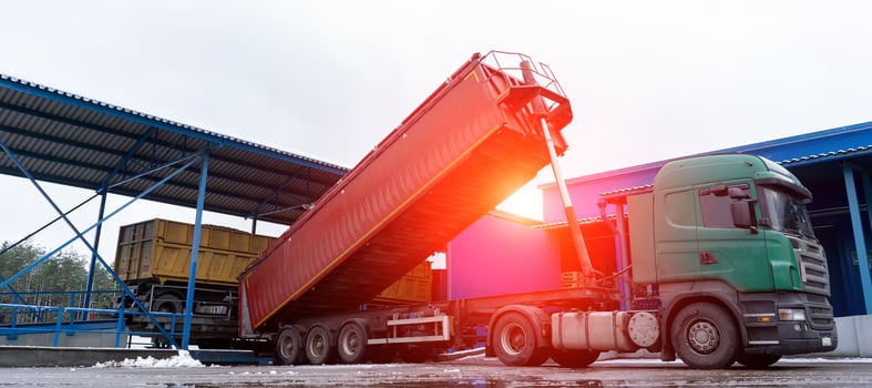 A truck unloads products at the factory at dawn photo