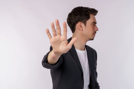Portrait of young handsome businessman doing stop sing with palm of the hand over white background photo