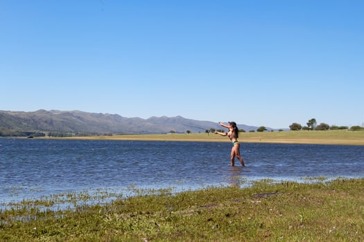 beautiful young woman fishing the mountain lake photo