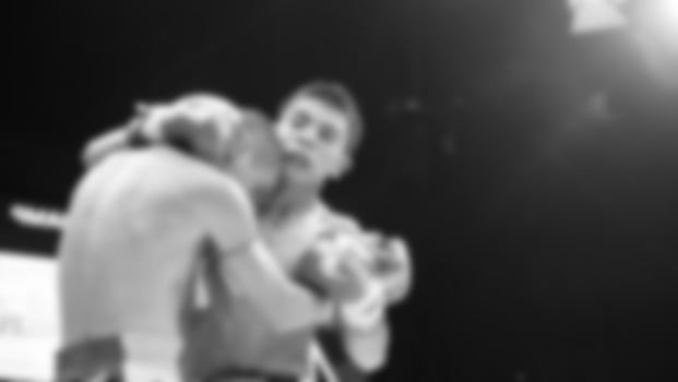 Blurred images black and white photo style of Thai boxing or Muay Thai or Kickboxing which local and foriegn boxer are fighting on the ring at indoor stage as martial art sport. Muay Thai Kick boxing