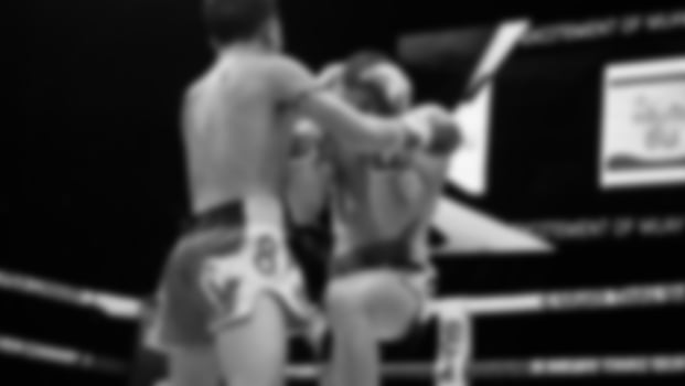 Blurred images black and white photo style of Thai boxing or Muay Thai or Kickboxing which local and foriegn boxer are fighting on the ring at indoor stage as martial art sport. Muay Thai Kick boxing