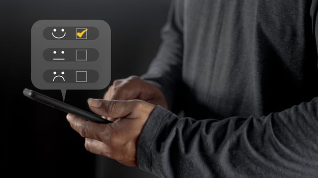 Businessman pressing smiley face emoticon on virtual touch screen. User give rating to service experience on online application for Customer review satisfaction feedback survey concept. photo