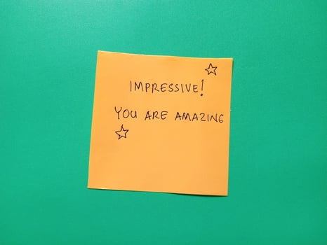 greeting text written on yellow paper and isolated on green background photo