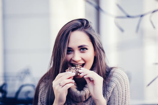 woman eating cookie photo