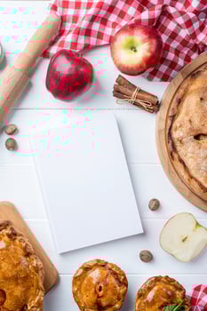blank cooking book cover mockup with apple pie, meat pie and seasonal fruit photo