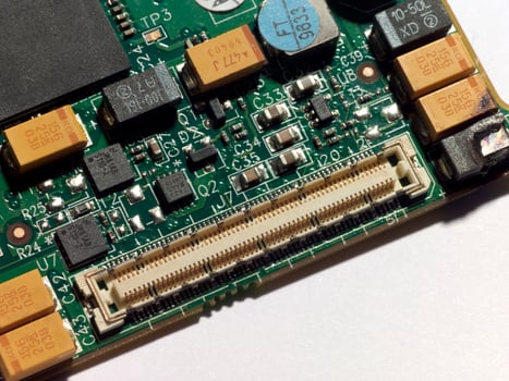 A computer circuit board with fire damage photo