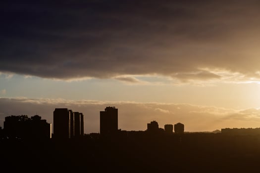 Silhouette shot of sunset over city photo