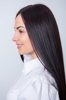 Beautiful young woman with long black hair in a beauty salon. photo