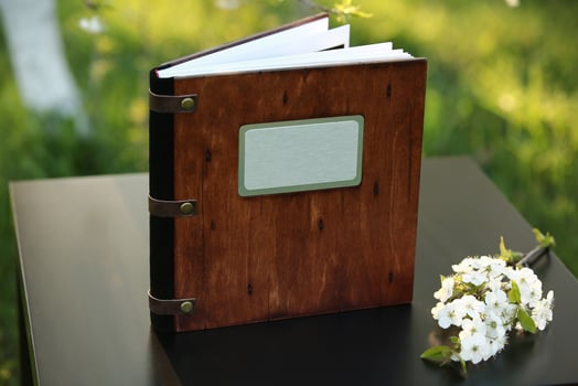wooden photobook on the table. place for the inscription photo