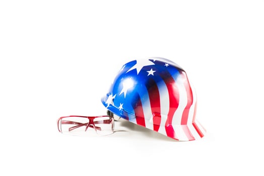 Safety items for construction sites. American helmet with color flag and safety glasses. photo