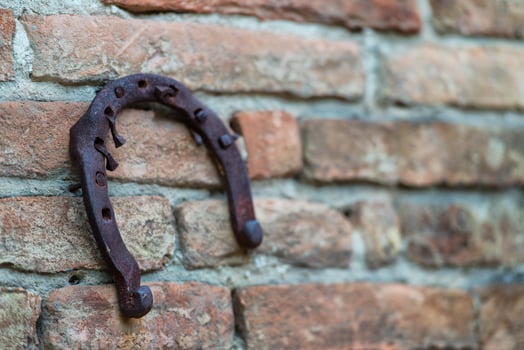Horseshoe hanging on an old wall photo