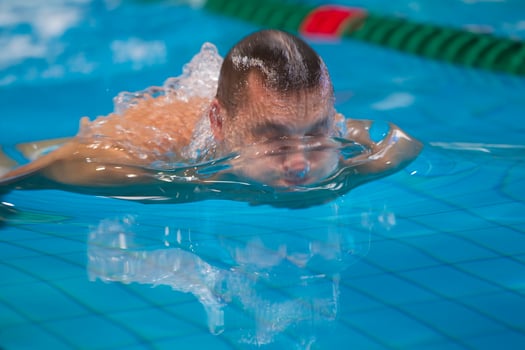 A man swims in the pool close-up. photo