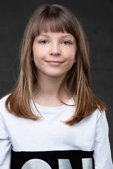 A beautiful ten year old girl is looking at the camera and smiling. photo