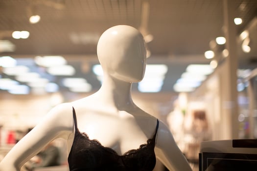 Mannequin of a woman in a bra in a shop window. photo