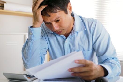 Businessmen are reading bills for expenses within the office. Serious facial expressions. Loss and debt photo