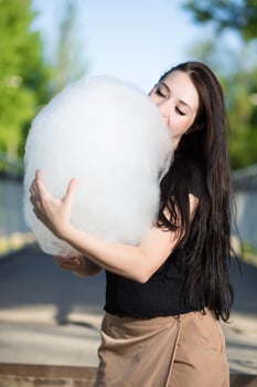 Young brunette with cotton candy photo