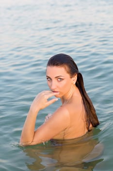 attractive wet young woman in the water photo