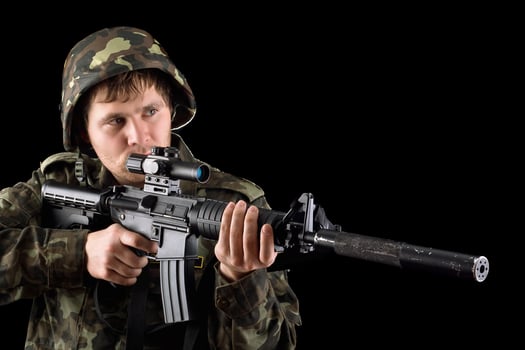 Aiming soldier with a rifle photo