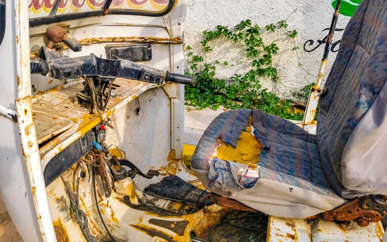 Old white broken wrecked tuk tuk rikshaw wreck in Mexico. photo