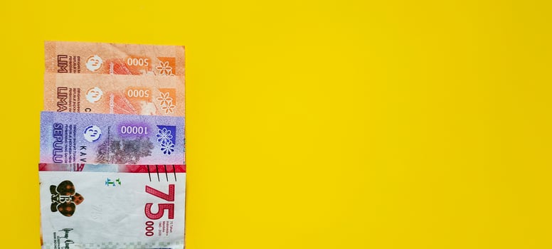 New Indonesian banknotes isolated on yellow background. photo