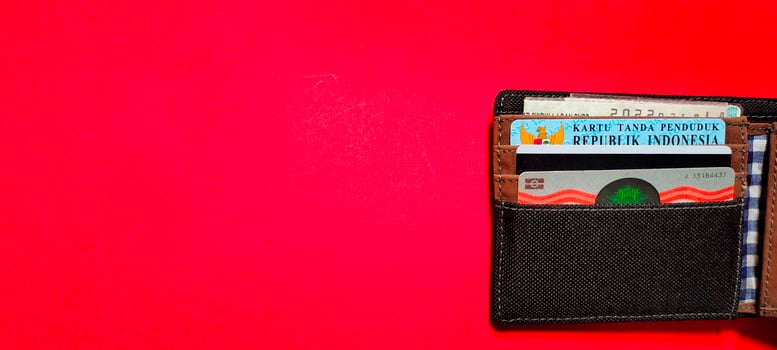 Black wallet containing driving card, residence card and motor vehicle certificate, Negative space. photo
