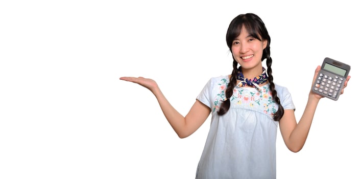Portrait of beautiful young asian woman in denim dress holding calculator on white background. business shopping online concept. photo