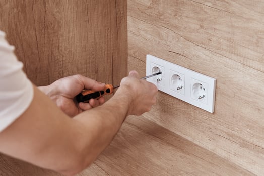 Electrician installing socket in the kitchen photo