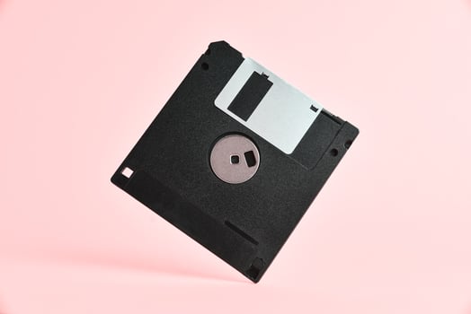 Floppy disk on pink background photo