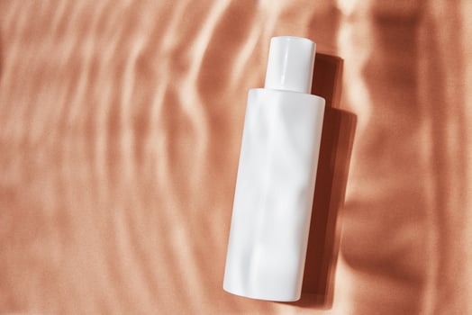 Cosmetics beauty mockup. White bottle on pastel ripples background photo