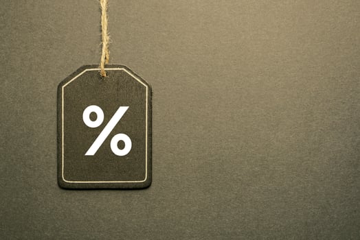 percent sign on the black price tag, black mockup background photo