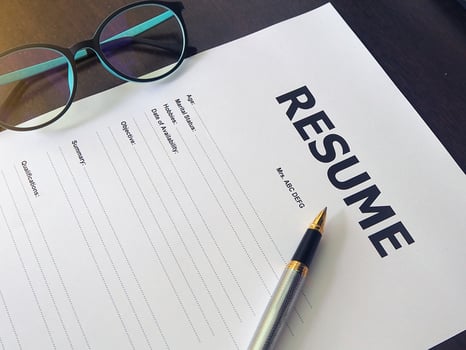 Resume Form Have pens and glasses. Closeup of Resume. photo