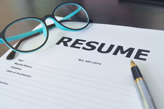 Job application form have pens and glasses. Close up of Resume photo