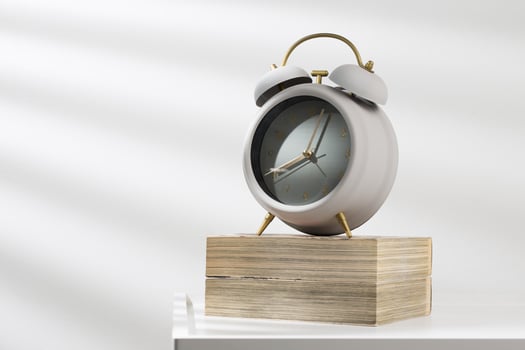 Minimalist gray alarm clock on the comic book and morning light. photo