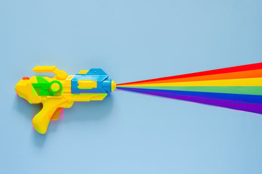 Water gun spray out with colorful cutting paper for Songkran festival celebration on blue color background. Minimal holiday concept. photo