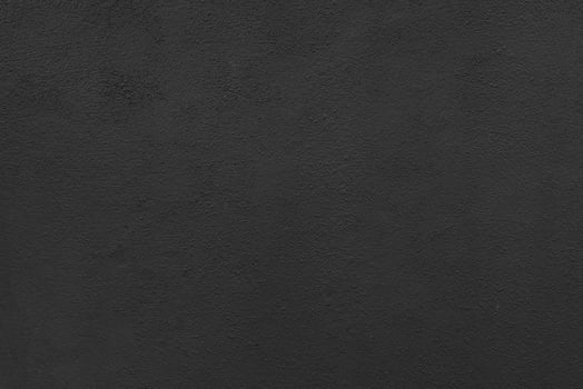 Dark black cement wall with rustic natural texture for abstract background and design purpose photo