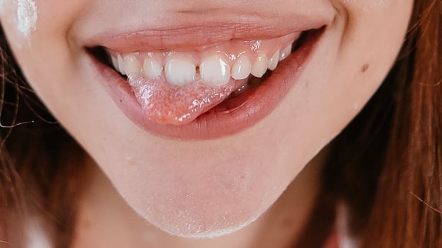 close-up of beautiful female smile with tongue out photo