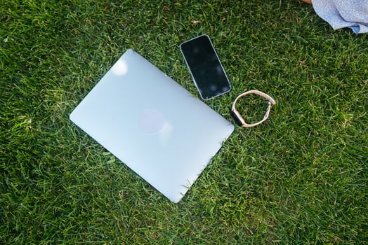 Laptop on green grass in park. Close view photo
